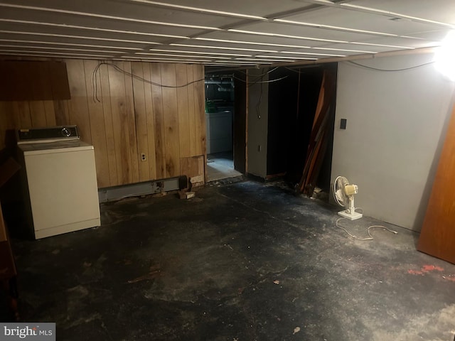 basement with washer / clothes dryer and wood walls