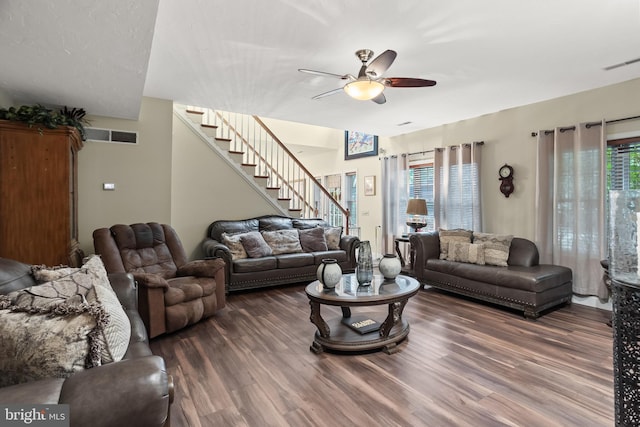 living room with ceiling fan, plenty of natural light, and dark hardwood / wood-style floors