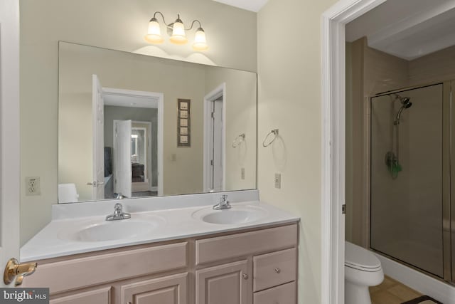 bathroom with vanity, toilet, and an enclosed shower