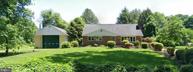 view of front of property with a front lawn and an outbuilding