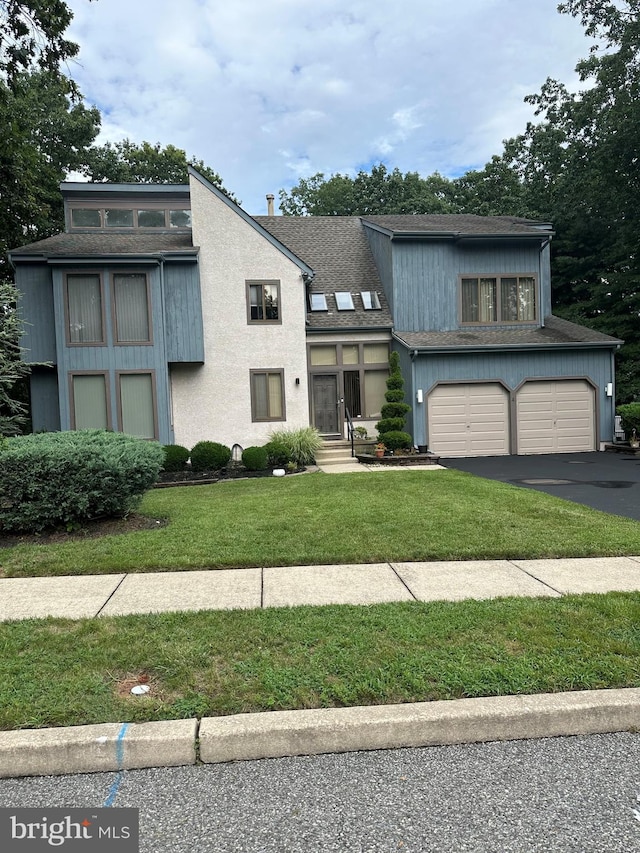 view of front facade with a garage and a front lawn