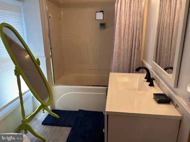 14352 Charmian Rd, Waynesboro, PA 17268 - full bath with wood finished floors, vanity, and shower / bath combo