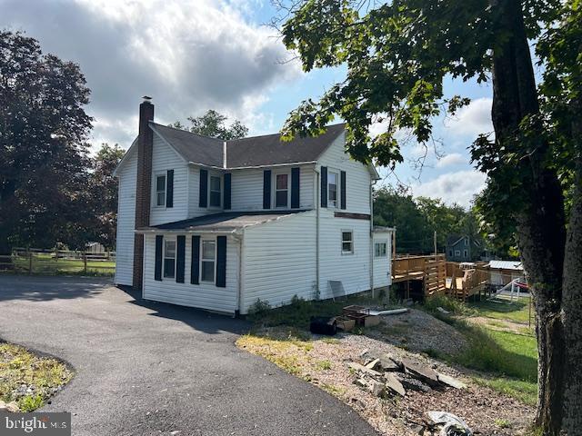 14352 Charmian Rd, Waynesboro, PA 17268 - view of side of property with a chimney, aphalt driveway, and a deck