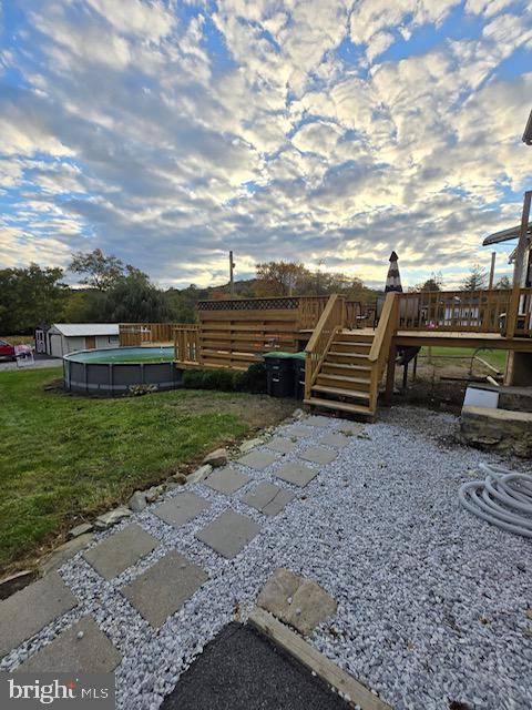 14352 Charmian Rd, Waynesboro, PA 17268 - view of yard with stairway, a wooden deck, fence, and an outdoor pool