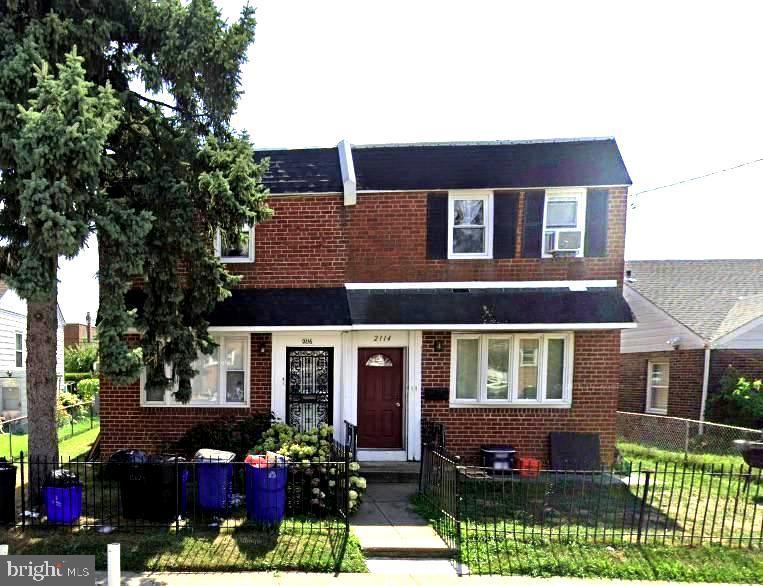 townhome / multi-family property featuring a front yard and cooling unit