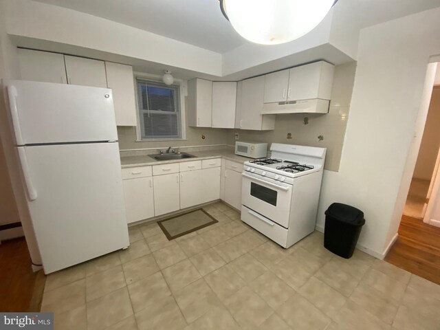 kitchen featuring white cabinetry, white appliances, tasteful backsplash, sink, and light hardwood / wood-style floors