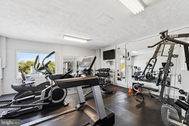 gym featuring a textured ceiling