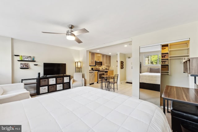 bedroom featuring recessed lighting, baseboards, a ceiling fan, a closet, and light tile patterned flooring