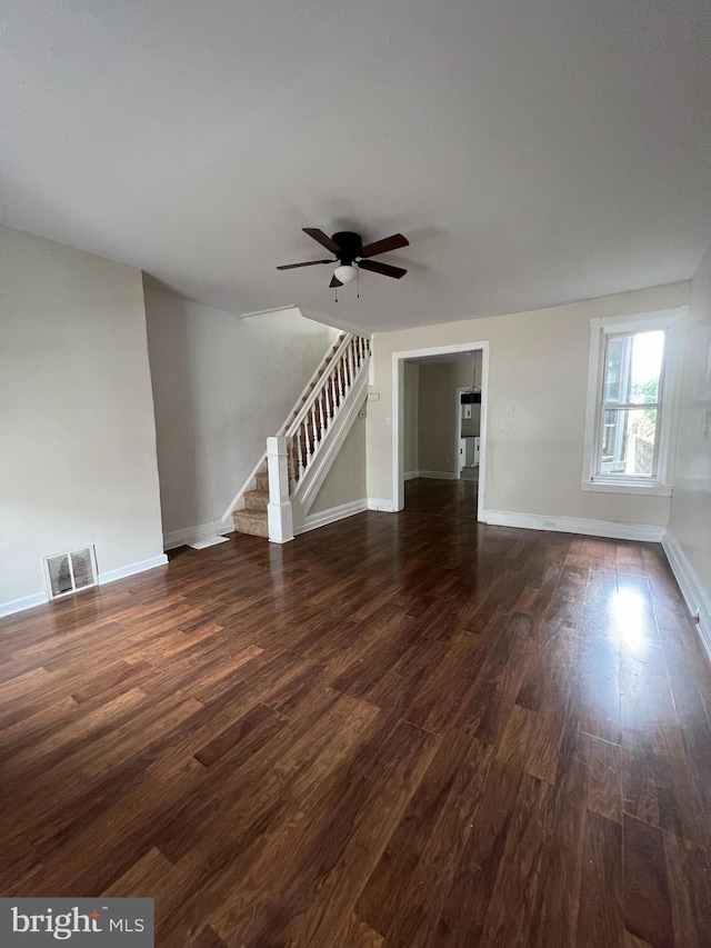 unfurnished living room featuring dark hardwood / wood-style floors and ceiling fan