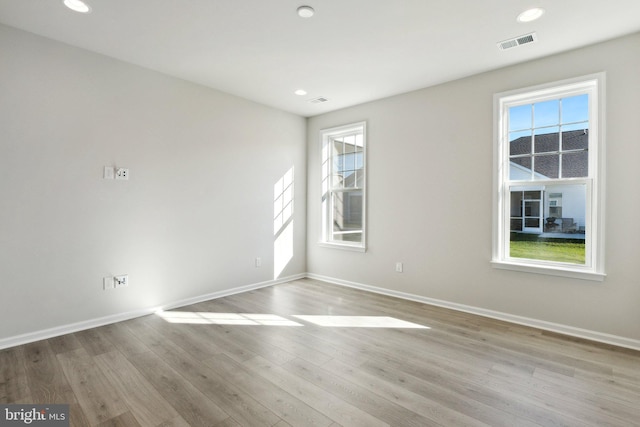 empty room featuring recessed lighting, visible vents, baseboards, and wood finished floors