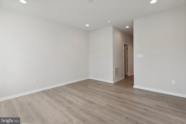 unfurnished room featuring recessed lighting, visible vents, baseboards, and wood finished floors