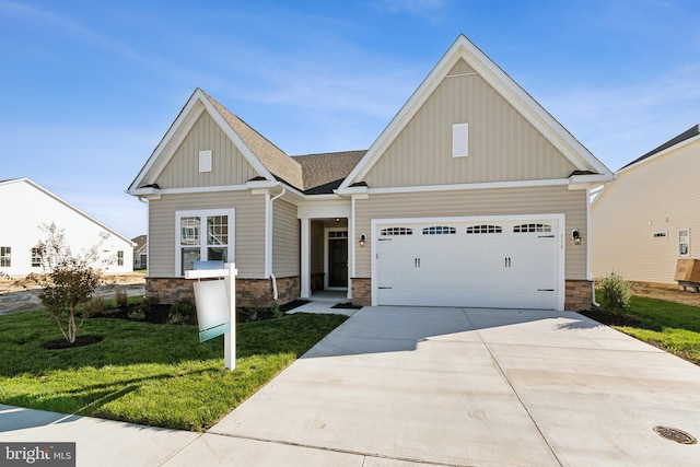 craftsman inspired home with an attached garage, driveway, stone siding, board and batten siding, and a front yard