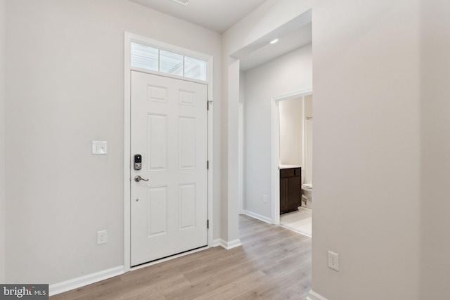 foyer entrance with light hardwood / wood-style flooring