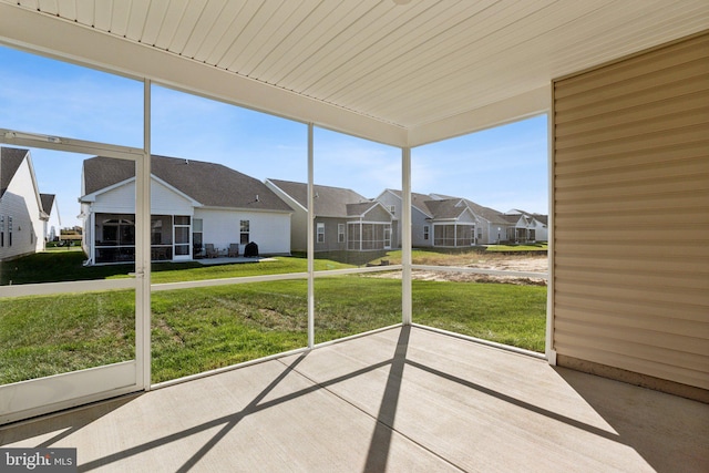 unfurnished sunroom with a residential view