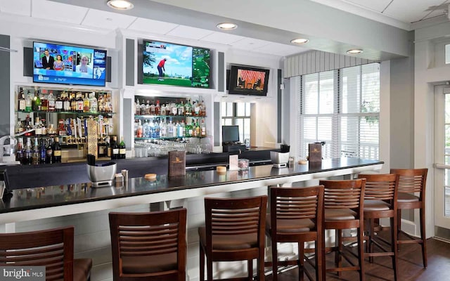 bar with hardwood / wood-style floors