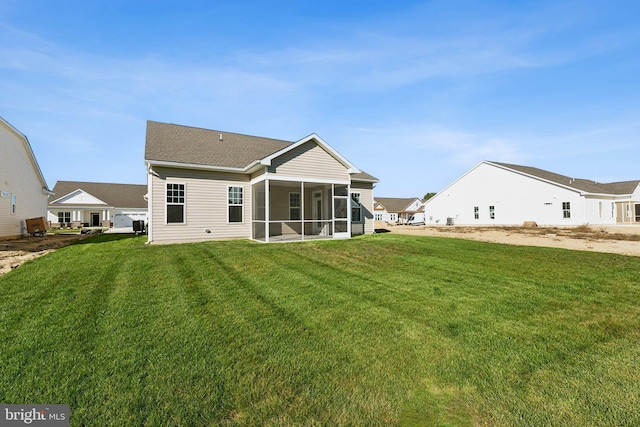 back of property featuring a yard and a sunroom