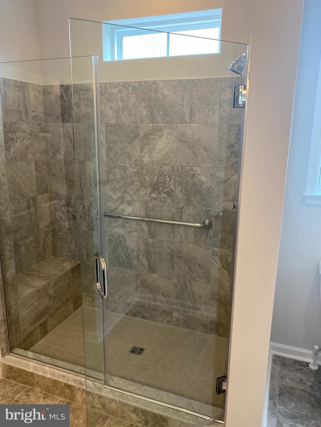 bathroom featuring a shower with shower door