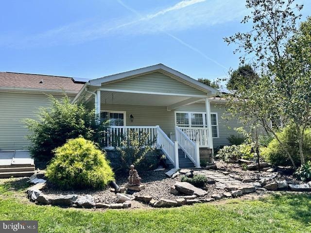 rear view of property with covered porch