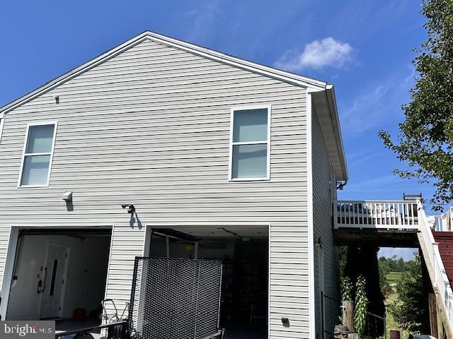 view of side of home with a deck