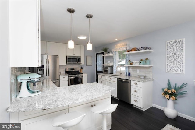 kitchen with open shelves, stainless steel appliances, decorative backsplash, a sink, and a peninsula