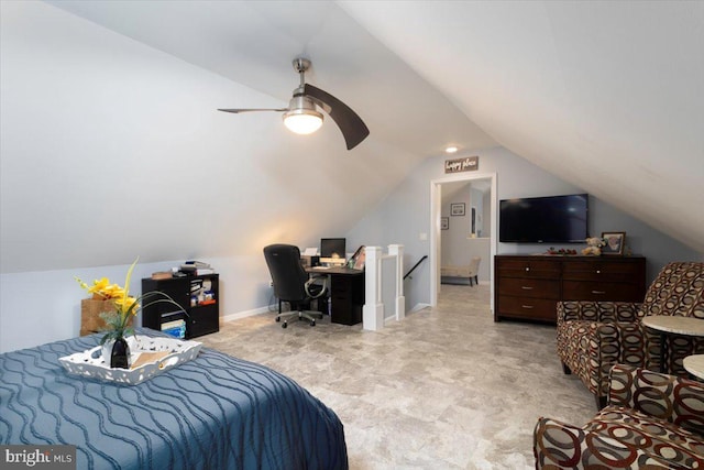 bedroom with a ceiling fan, vaulted ceiling, and baseboards