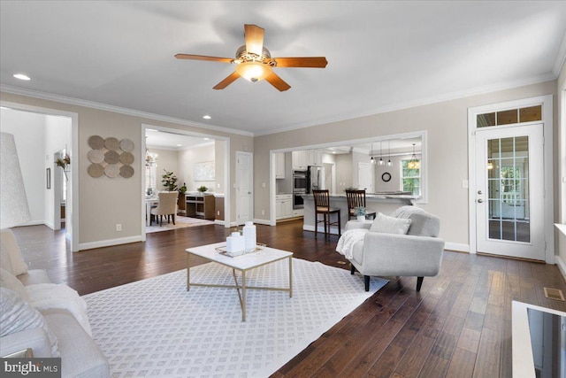 living room with ceiling fan, dark hardwood / wood-style flooring, and ornamental molding