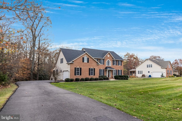 view of front of property featuring a front yard and a garage