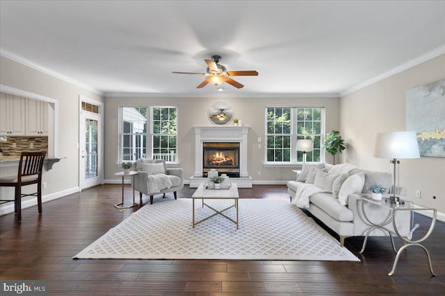 living room with dark hardwood / wood-style floors, crown molding, and a healthy amount of sunlight