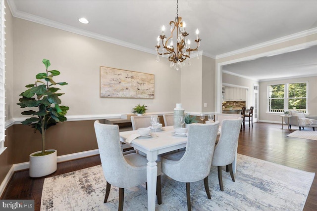 dining area featuring a chandelier, crown molding, and dark wood-type flooring