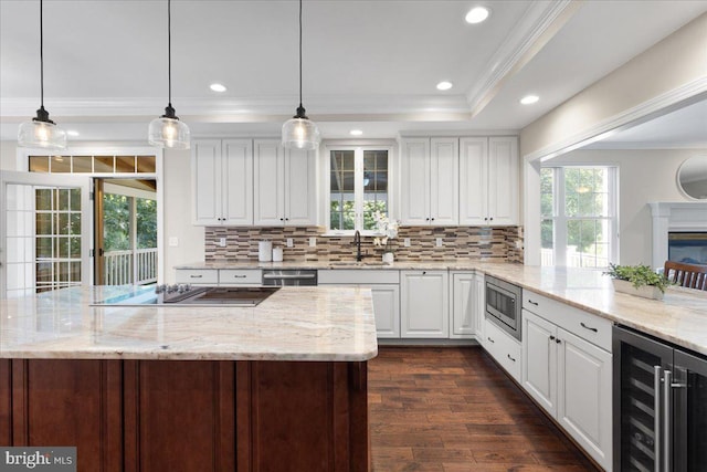 kitchen featuring wine cooler, white cabinets, hanging light fixtures, and dark hardwood / wood-style floors