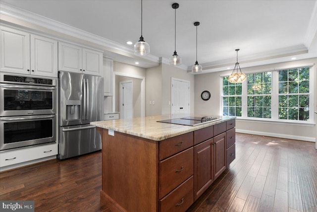 kitchen with a center island, white cabinets, dark hardwood / wood-style floors, light stone countertops, and stainless steel appliances