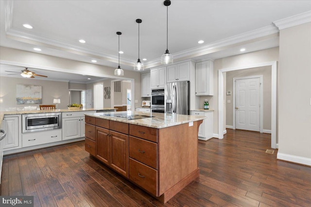 kitchen with white cabinets, a center island, stainless steel appliances, and dark wood-type flooring