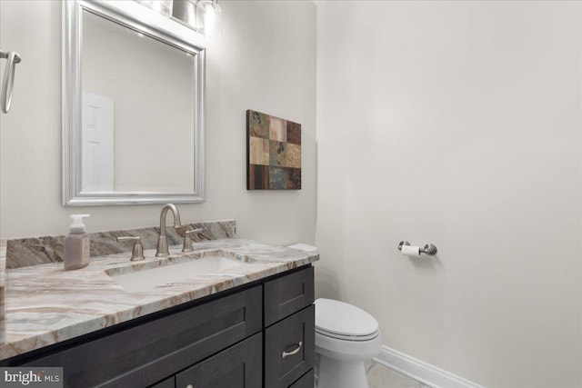 bathroom with tile patterned floors, vanity, and toilet