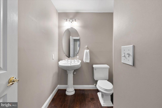 bathroom with hardwood / wood-style floors and toilet