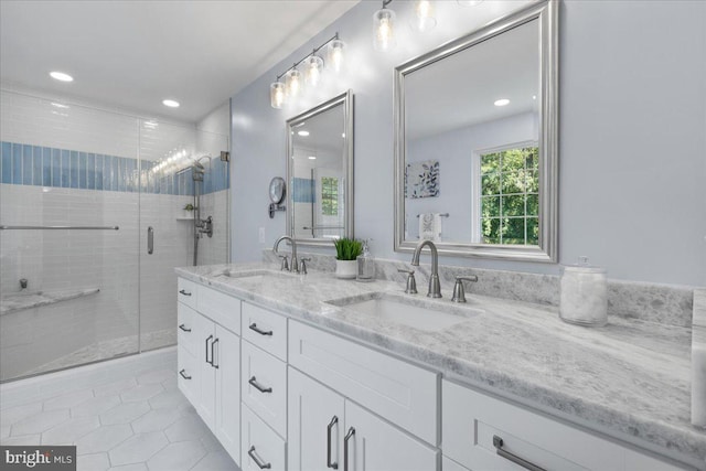 bathroom featuring vanity, tile patterned floors, and walk in shower