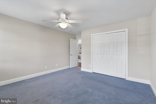 unfurnished bedroom with ceiling fan, a closet, and dark carpet