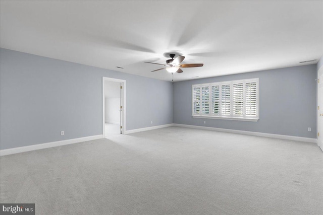 carpeted spare room with ceiling fan