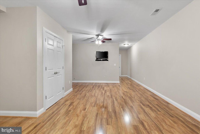 unfurnished living room with ceiling fan and light wood-type flooring