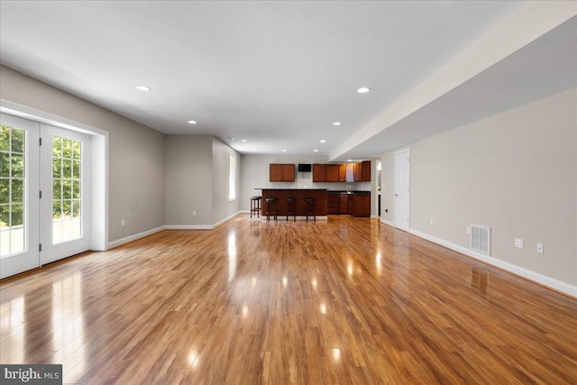 unfurnished living room with light wood-type flooring