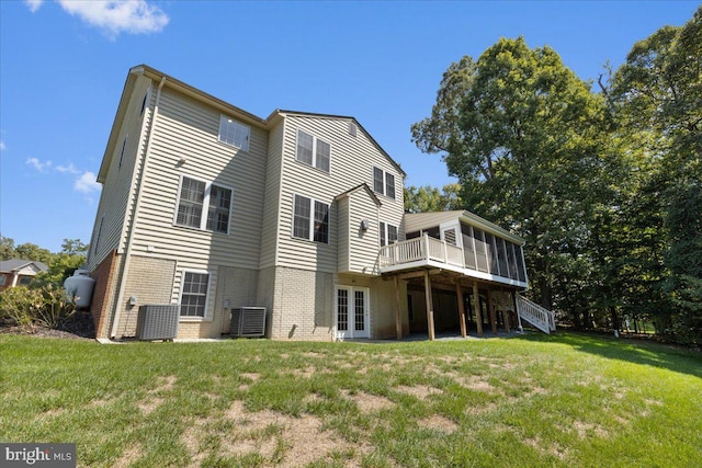 back of house with a yard, a wooden deck, french doors, and central AC unit