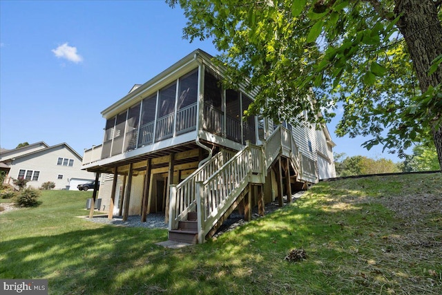 back of property featuring a sunroom and a yard