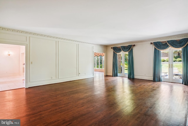 interior space featuring baseboard heating, dark hardwood / wood-style floors, and a healthy amount of sunlight