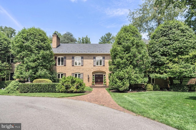 colonial-style house with a front yard