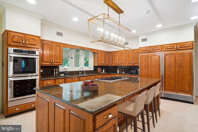 kitchen with appliances with stainless steel finishes, backsplash, a kitchen island, and crown molding