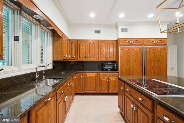 kitchen featuring electric stovetop, ornamental molding, light tile patterned floors, sink, and dark stone counters