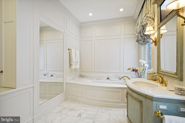 bathroom with vanity, a bathtub, and crown molding