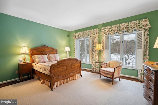 carpeted bedroom with multiple windows and crown molding