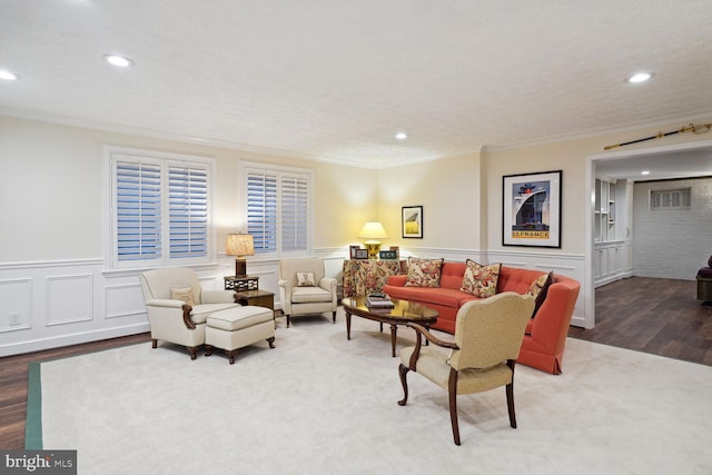 living room featuring ornamental molding and hardwood / wood-style flooring