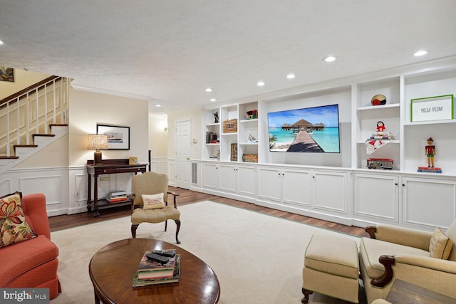 living room with light hardwood / wood-style flooring and a textured ceiling