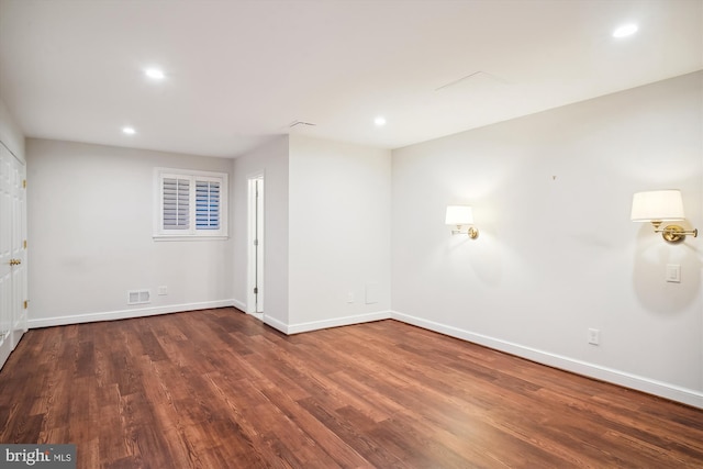 unfurnished room featuring dark wood-type flooring